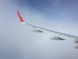 View of clouds from the airplane.Aerial view of cloud and blue sky with wing's airplane.Traveling and journey concept.