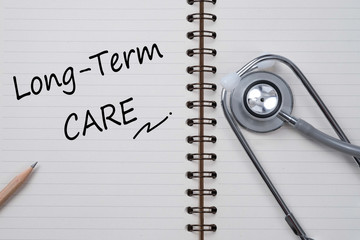 Stethoscope on notebook and pencil with Long Term Care words as
