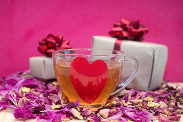 boxes with gifts with rose petalsand glass cup tea with red heart,concept for Valentines day, anniversary, romantic gift.