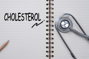 Stethoscope on notebook and pencil with CHOLESTEROL words as med