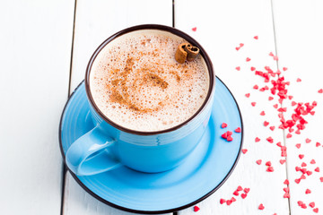 cocoa in a mug and red hearts on a white background