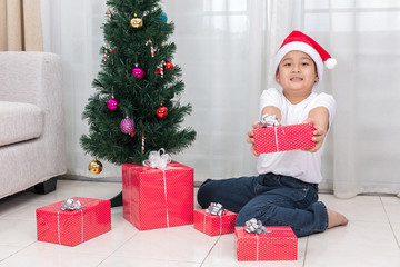 Asian Chinese little boy holding Christmas gift box