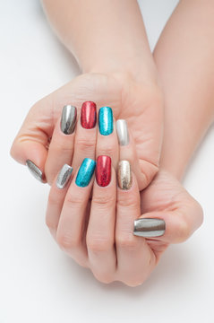 New Year's manicure on long square nails red, blue, black, gold, silver with a flower in the hands