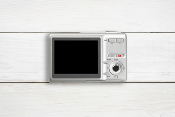 silver digital compact camera with blank black screen display pl