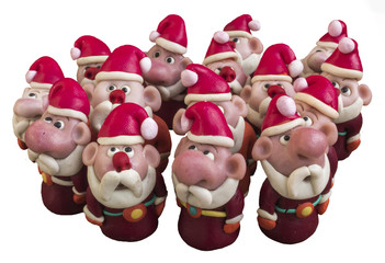 Obraz premium Santa Clauses from modeling clay. Santa Clauses on a white background.