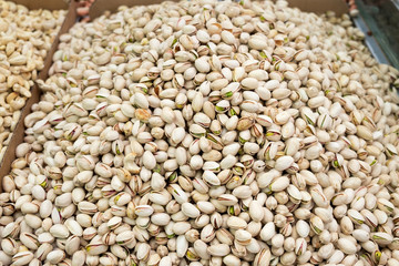Fototapeta premium Roasted and salted pistachios for sale at city market