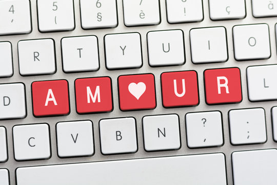 AMOUR writing on white keyboard with a heart sketch