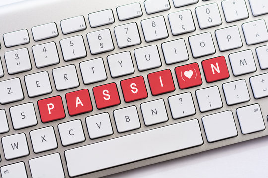 PASSION writing on white keyboard with a heart sketch with paren