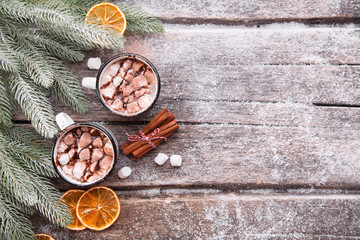 Delicious cocoa with marshmallows on a wooden table.