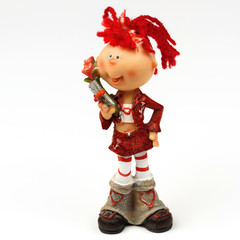 Toy the girl's figure with a flower close up on a white background.