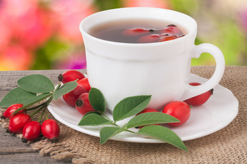 Tea from the hips on the wooden table with a blurred background
