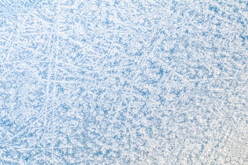 Fototapeta na wymiar Winter background light texture. Frost pattern on car window in