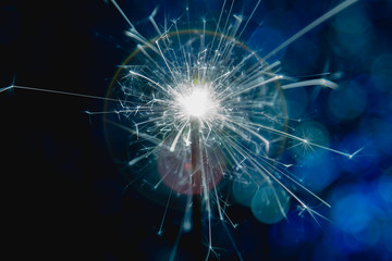 Color blue style. Christmas and New Year party sparkler with abstract circular bokeh background Christmas lights.