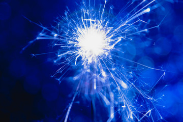 Color blue style. Christmas and New Year party sparkler with abstract circular bokeh background Christmas lights.