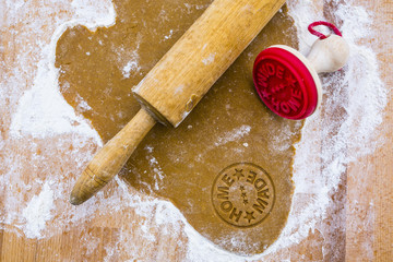 Dough homemade gingerbread on a wooden pastry board. Christmas homemade pastries. 