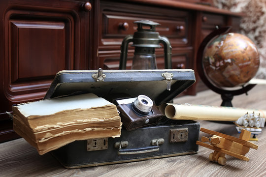 composition on a wooden floor vintage globe with old leather sui - Powered by Adobe