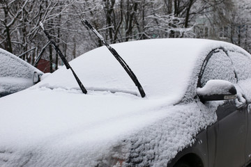 car in a winter morning with snow covered