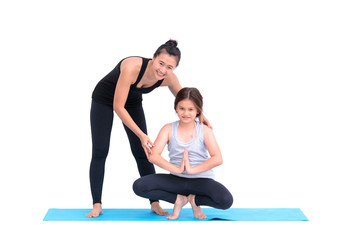 Obraz premium Smiling girl practicing yoga poses and her instructor in yoga cl