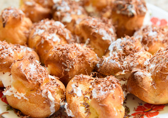 Profiteroles with cream and chocolate shavings
