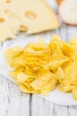 Portion of Potato Chips (Cheese and Onoion taste) on wooden back