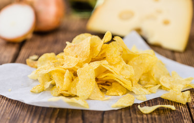 Portion of Potato Chips (Cheese and Onoion taste) on wooden back