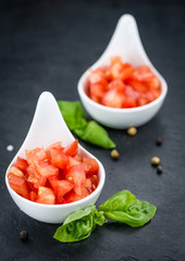Portion of Tomatoes (diced) on a slate slab