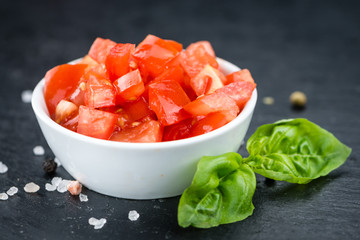 Cutted Tomatoes on a vintage slate slab (selective focus)