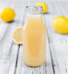 Fresh made Lemon Juice on a rustic background