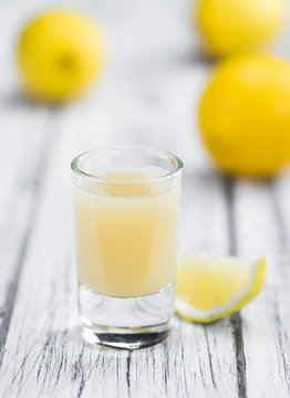 Wooden table with Lemon Juice (selective focus)