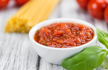 Wooden table with Tomato Sauce (selective focus)
