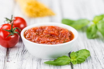 Wooden table with Tomato Sauce (selective focus)