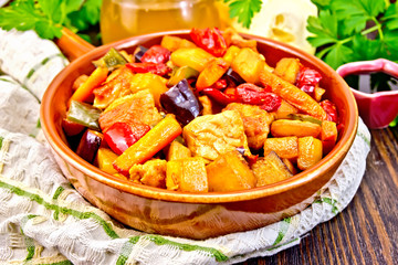 Roast with vegetables and honey in pan on dark board