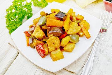 Roast with vegetables and honey in plate on light board