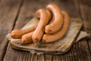 Sausages (Frankfurter) on vintage wooden background