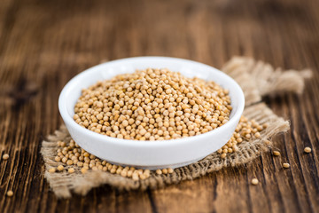 Mustard Seeds on vintage wooden background