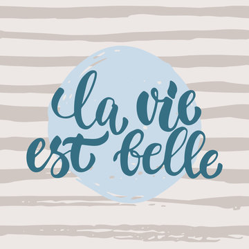 la vie est belle - hand drawn French lettering phrase it means Life is beautiful isolated on striped grunge background. Fun brush ink inscription for greeting card or t-shirt print, poster design