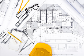 Construction plans with Tablet, drawing and working Tools on blu