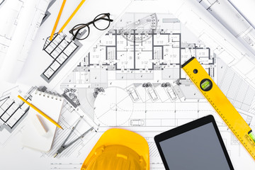 Construction plans with Tablet, drawing and working Tools on blu