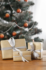 Christmas present on decorated tree background, holiday concept