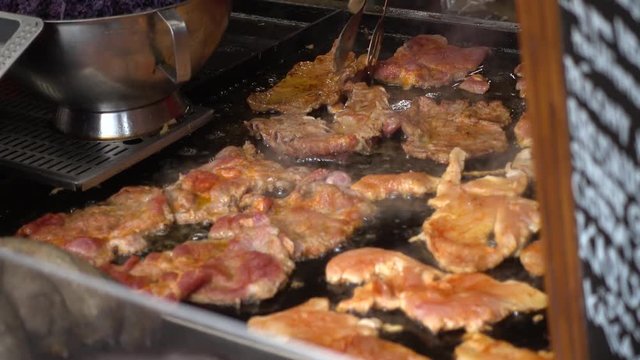 Meat is fried in oil on Christmas fair