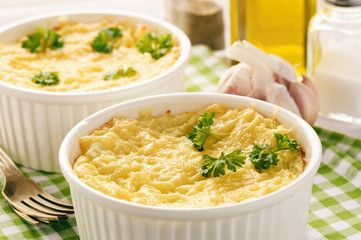 Shepherd pie on white wooden background.