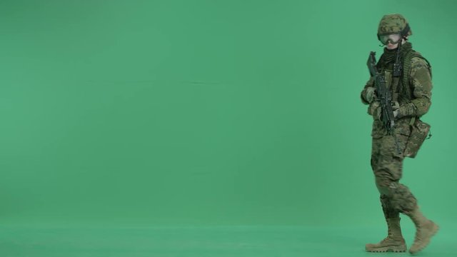 serviceman targeting at the camera at green screen