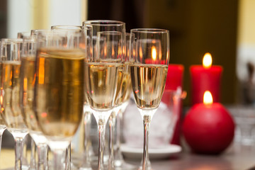A lot of wine glasses with a cool delicious champagne or white wine at the bar