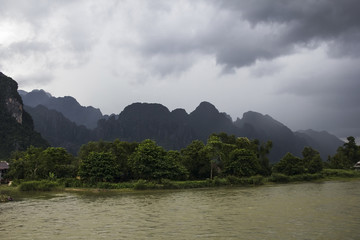 misty mountains by a river in laos