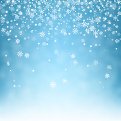 Fototapeta na wymiar Flying snowflakes on blue background.