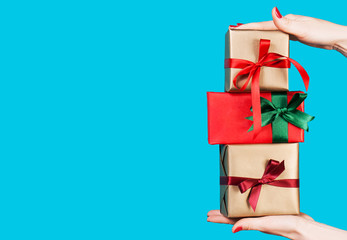 Hand of young woman holding many beautiful gift boxes, copy spac