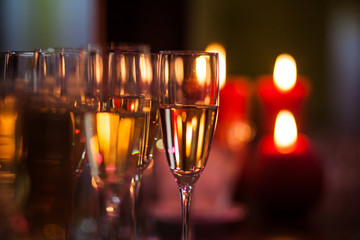 A lot of wine glasses with a cool delicious champagne or white wine at the bar
