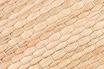 Bamboo woven beige mat handmade background. Wicker wood texture. Diagonal strips.