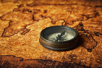 Fototapeta na wymiar Old vintage compass on ancient map