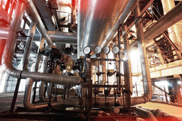 Equipment, cables and piping as found inside of a modern industr